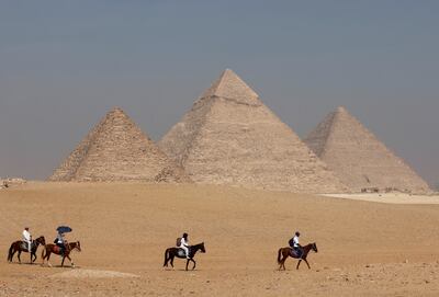 Tourists ride horses in front of the Great Pyramid in Giza, on the outskirts of Cairo. Reuters