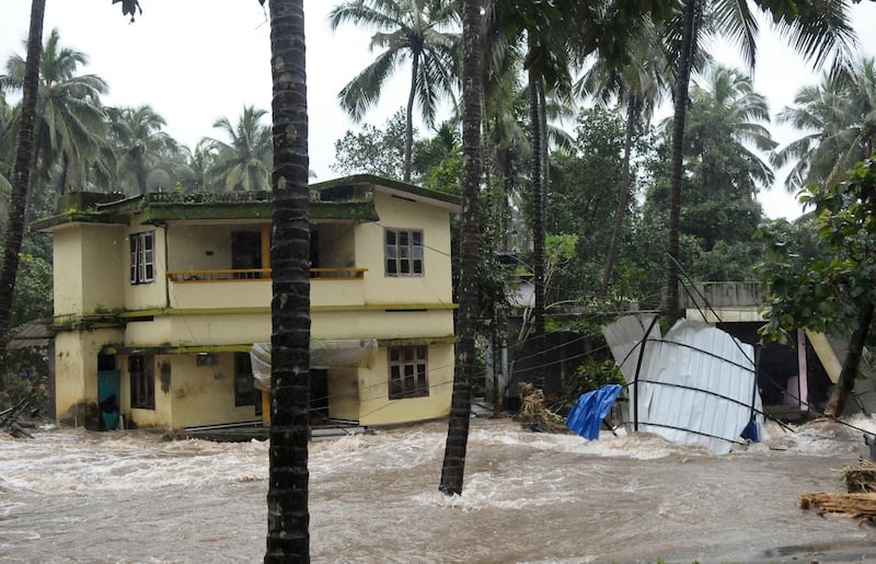 Roads and houses are engulfed in water following heavy rain and landslide in Kozhikode, Kerala state, India, Thursday, Aug. 9, 2018. Landslides triggered by heavy monsoon rains have killed more than a dozen people in southern India, cutting off road links and submerging several villages. (AP Photo)