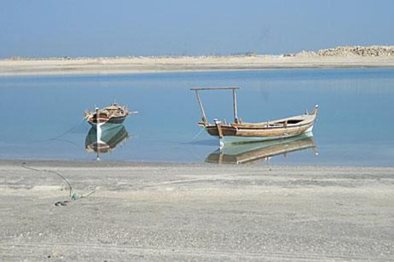 Visions of yesterday: Two boats await visitors wanting to experience life as fishermen or pearl divers.