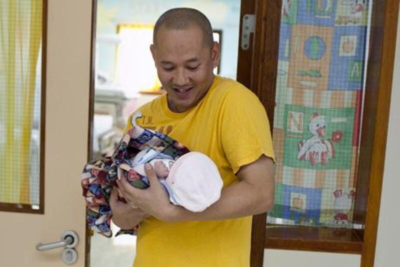 Abu Dhabi, United Arab Emirates, December 02, 2012:  
One-day-old baby girl Simone Therese Amora, who was born 57 minutes after midnight on December 2, 2012, as one of the first babies on the National Day in the Corniche Hospital in Abu Dhabi, rests in her father's arms as he tenderly caries her back to her mom. Simone, who was born through a caesarian section, is the first baby for her father Roel Amora.

Silvia Razgova / The National


