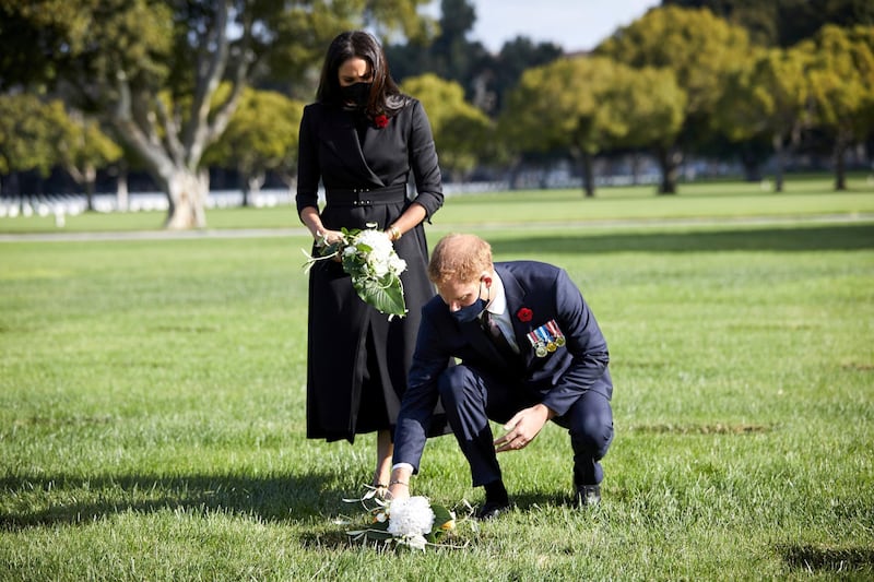 Britain's Prince Harry and Meghan, Duchess of Sussex lay flowers as they visit the Los Angeles National Cemetery in honour of Remembrance Sunday, in Los Angeles, California, U.S., November 8, 2020.  LEE MORGAN/Handout via REUTERS THIS IMAGE HAS BEEN SUPPLIED BY A THIRD PARTY. MANDATORY CREDIT. NO RESALES. NO ARCHIVES.