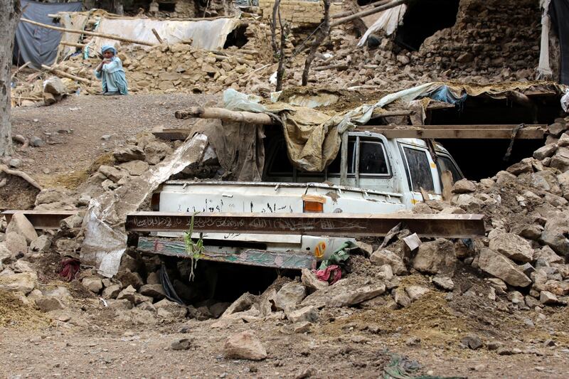 An Afghan villager sits near his damaged house that was destroyed in an earthquake in the Spera District of the southwestern part of Khost Province, Afghanistan. AP