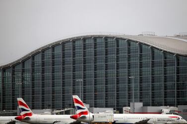 Aircraft await take-off at Heathrow Airport as British officials examine coronavirus changes for air corridors ahead of Thursday meeting. British Airways
