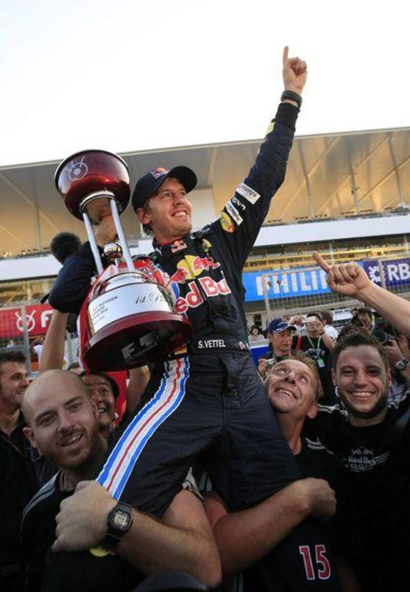 Red Bull driver Sebastian Vettel of Germany celebrates with his team after winning the Japanese Grand Prix at Suzuka. The result keeps the German in contention for the world title with two races left of the season.