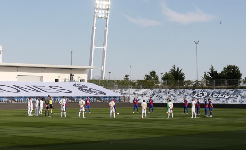 Real Madrid and Eibar players observe a minute of silence in honor of victims of the coronavirus pandemic ahead of the game. EPA