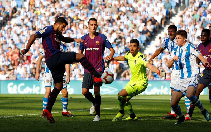 Barcelona's Luis Suarez scores Barcelona's first goal. Reuters