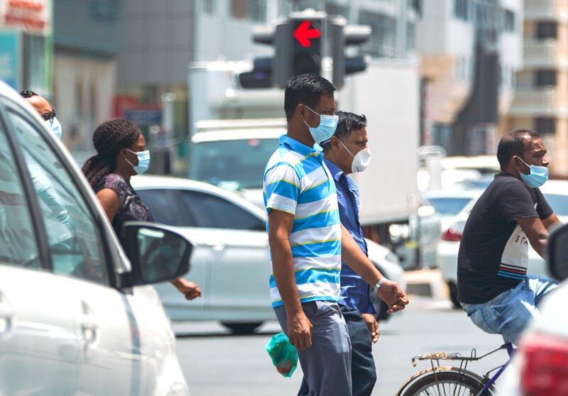 Abu Dhabi, United Arab Emirates, June 3, 2020.   
Pedestrians protect themselves with face masks during the Covid-19 pandemic while crossing the street at downtown Abu Dhabi.
Victor Besa  / The National
Section:  Standalone / Stock