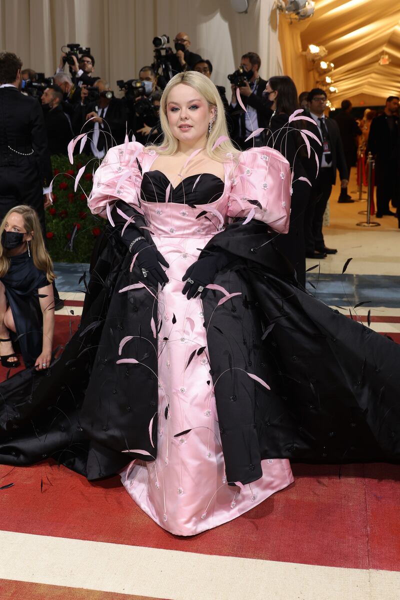 Nicola Coughlan, wearing a black and pink gown. AFP