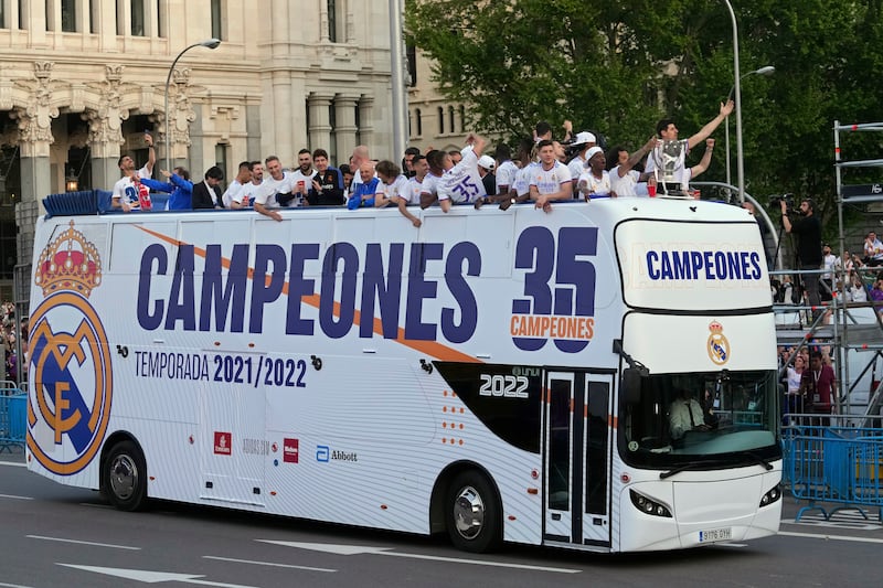 Real Madrid players celebrate on an open top bus through the streets of Madrid after winning the Spanish title. AP