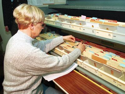 An employee searches for record cards of the archive of the former east German Ministry for Security or "Stasi" in the filing cabinet inside the headquarters in Berlin December 22. Huge cache of thousands of packs filled with shredded documents and records cards of the former East German secret police are collected in the archive. The Gauck Authority, in charge of processing the archive, received million requests for information from individuals, justice authorities, police, government offices, companies, research centres and media. About 1.3 million of those were for personal files or help in identifying the code names used by the Stasi in their files to disguise the identity of their informants.