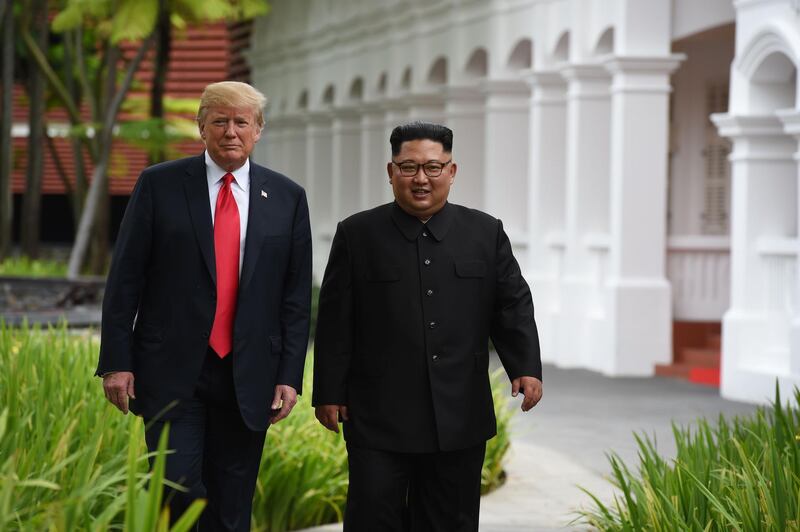 North Korea's leader Kim Jong-un walks with US President Donald Trump during a break in talks. Anthony Wallace / AFP