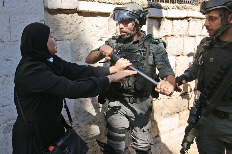 A Palestinian woman confronts Israeli security forces outside the Damascus gate in occupied east Jerusalem, ahead of the March of the Flags. AFP
