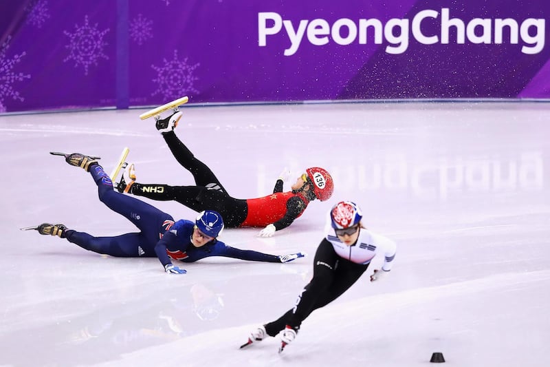 Jinyu Li of China and Elise Christie of Great Britain fall after contact as Minjeong Choi of Korea skates past during the Short Track Speed Skating Ladies' 1,500m Semifinals at the PyeongChang 2018 Winter Olympic Games at Gangneung Ice Arena. Dean Mouhtaropoulos / Getty Images