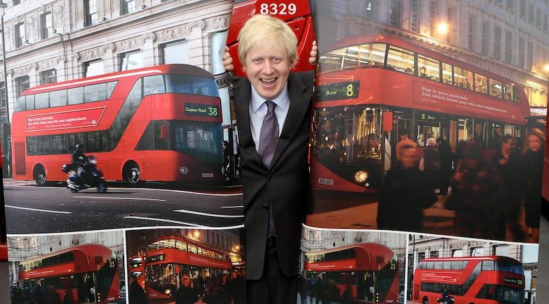 Mr Johnson with artists' impressions of the design for London's new Routemaster bus in May 2010. Getty Images