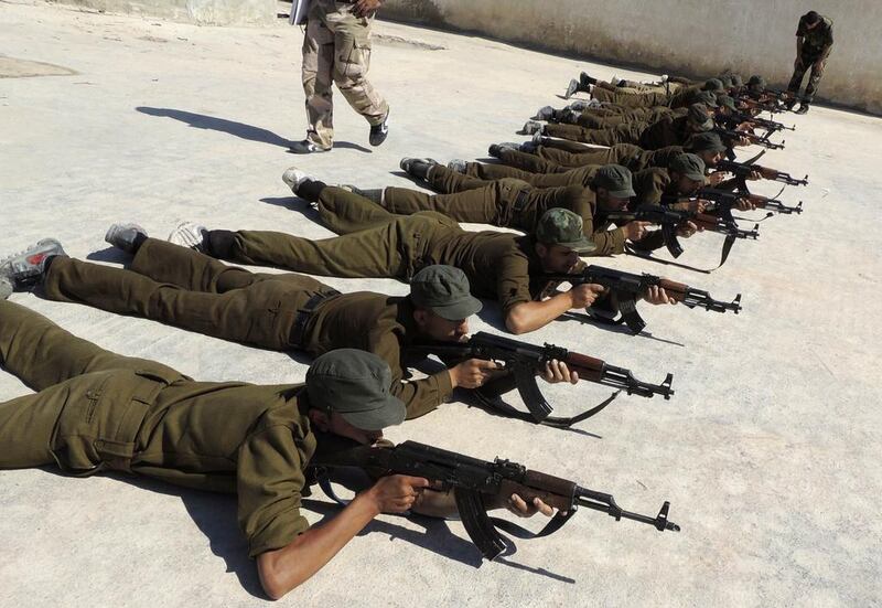 New recruits attend military training to be part of the Free Syrian Army in eastern Ghouta, near Damascus.

Reuters