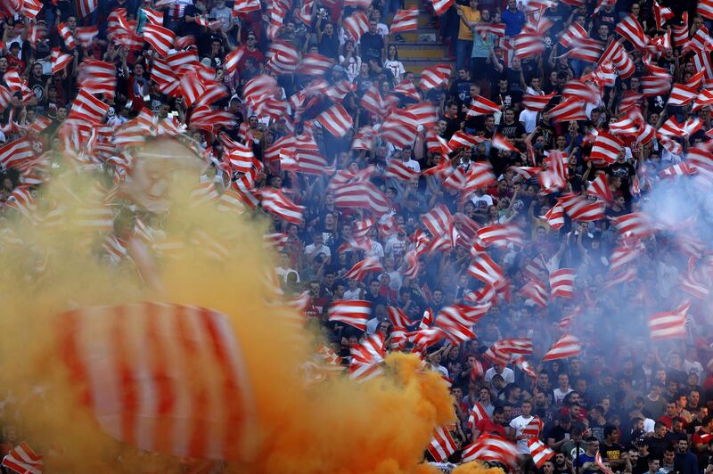 (FILES) In this file photograph taken on June 20, 2020, Red Star Belgrade supporters celebrate their team's third successive and record-extending 31st league title during the last match of the season, between FC Crvena Zvezda (FC Red Star) and FC Proleter Novi Sad at The "Rajko Mitic" Stadium in Belgrade. Five players from Serbian club Red Star Belgrade have tested positive for coronavirus after playing a match attended by 16,000 people, the club said June 22, 2020, The announcement came 12 days after Red Star played a derby match with Partizan Belgrade in front of a crowd of around 16,000 people, the largest gathering of that kind in Europe since the beginning of the pandemic.
 / AFP / Pedja Milosavljevic
