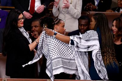 US representatives Rashida Tlaib, Cori Bush and Summer Lee put on Palestinian keffiyehs prior to President Joe Biden's State of the Union address on March 7. Reuters
