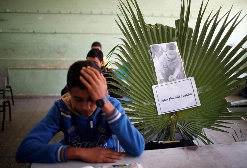 A picture of 14-year-old Palestinian boy, Khaled Saed, who was killed with two other teenagers in an Israeli air strike on the Gaza Strip frontier, is seen on a chair at a school in the central Gaza Strip. Reuters