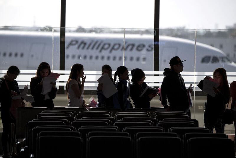 (FILES) In this file photo taken on February 18, 2018 Filipina workers returning home from Kuwait arrive at Manila International Airport.  Kuwait and the Philippines signed a deal on May 11, 2018 to regulate domestic workers, after a dispute between the two countries led to a ban on Filipino workers in the Gulf state."A short time ago we signed an agreement between the two countries on the employment of domestic workers," Foreign Minister Sheikh Sabah al-Khaled al-Sabah told a joint press conference with his Filipino counterpart Alan Peter Cayetano.
 / AFP / NOEL CELIS
