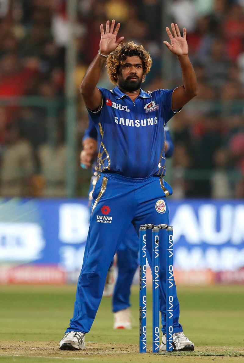 In this, Thursday, March 28, 2019 photo, Mumbai Indians' bowler Lasith Malinga gestures to his teammates after bowling the last delivery during the VIVO IPL T20 cricket match between Royal Challengers Bangalore and Mumbai Indians in Bangalore, India. Mumbai Indians won by six runs. (AP Photo/Aijaz Rahi)