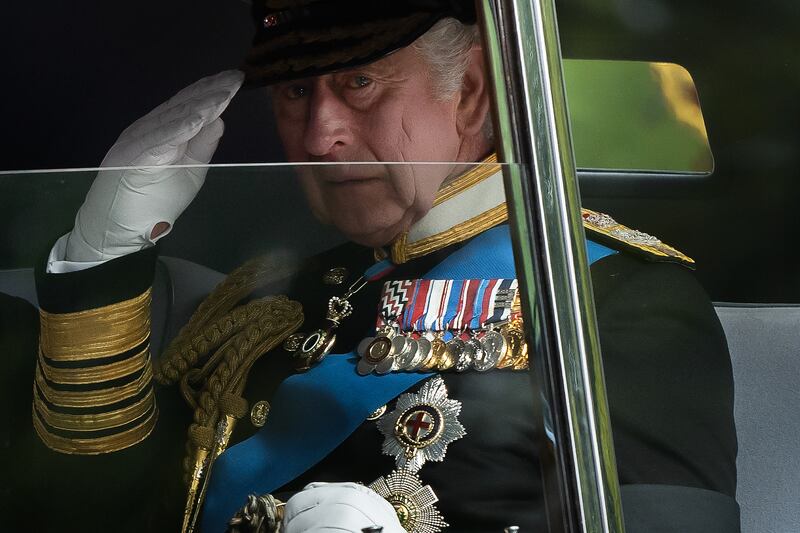 King Charles salutes as he is driven past Wellington Arch in London. Getty Images
