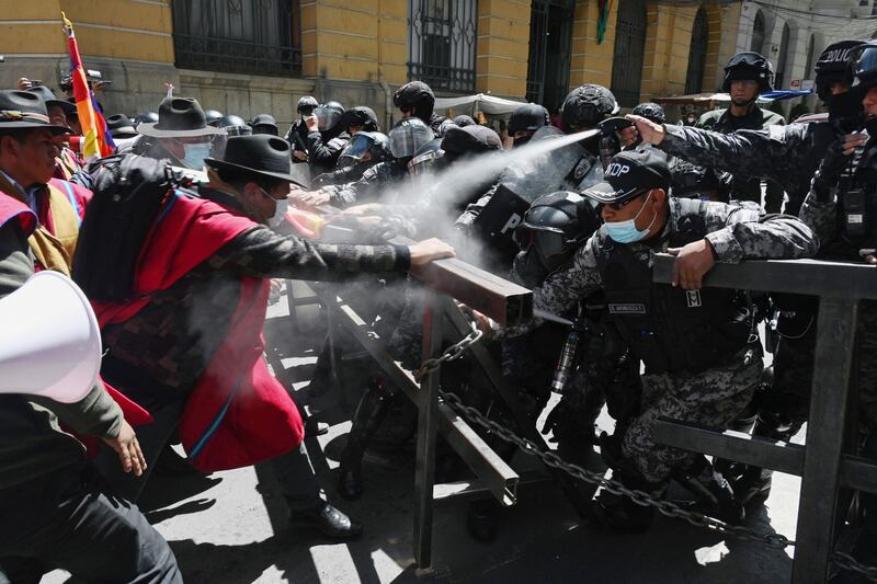 Indigenous peasants known as the Ponchos Rojos (Red Ponchos) from the Omasuyos province in the Bolivian highlands, clash with riot police after marching from the city of El Alto to the government headquarters in La Paz. The Ponchos Rojos are political allies of the ruling Movimiento Al Socialismo party. AFP