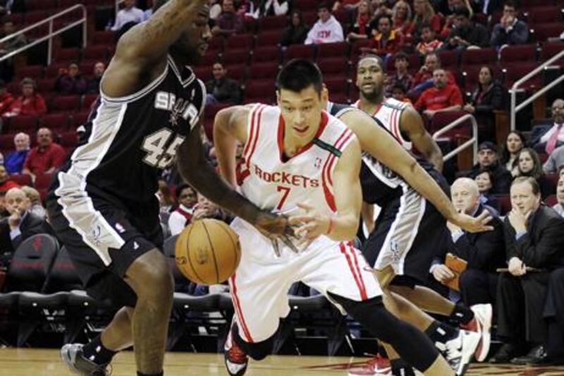 Jeremy Lin looks to drive the ball round San Antonio's DeJuan Blair.