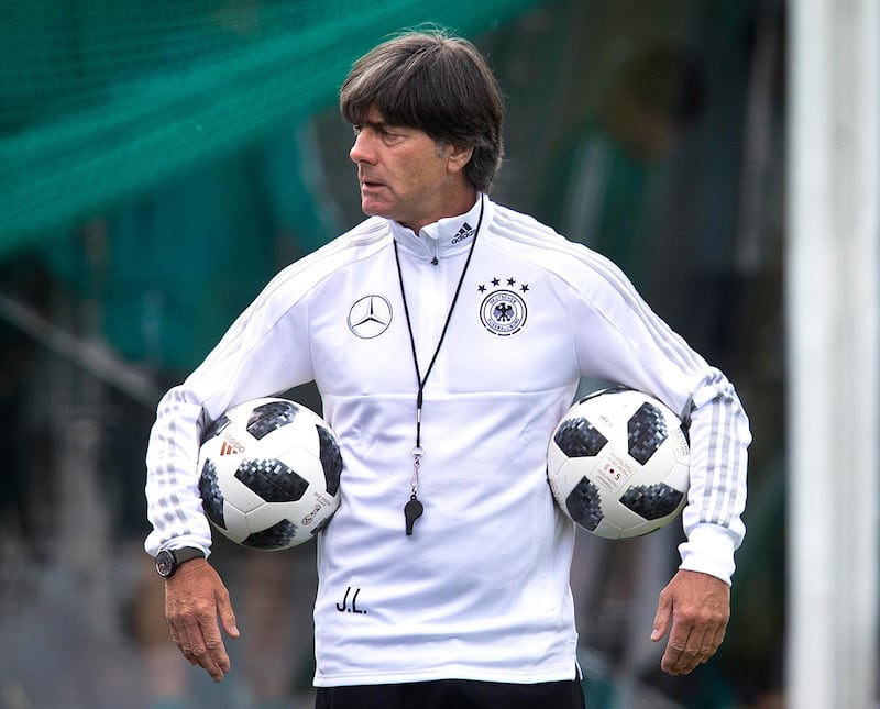 FILE - In this June 14, 2018 file photo, Coach of German national soccer team Joachim Loew carries two balls during a training session at the 2018 soccer World Cup in Vatutinki near Moscow, Russia. (AP Photo/Michael Probst,File)