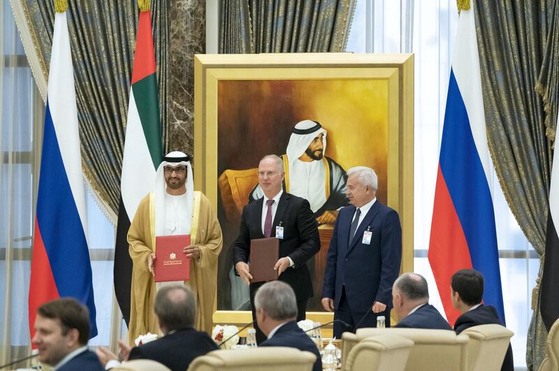 ABU DHABI, UNITED ARAB EMIRATES - October 15, 2019: HE Dr Sultan Ahmed Al Jaber, UAE Minister of State, Chairman of Masdar and CEO of ADNOC Group (L) exchanges an MOU with a Russian counterpart (C), during a state visit reception, at Qasr Al Watan. 

( Hamad Al Mansoori for the Ministry of Presidential Affairs )
---