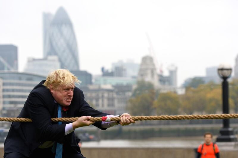 LONDON, ENGLAND - OCTOBER 27:  Mayor of London Boris Johnson competes in a tug of war during the launch of London Poppy Day on October 27, 2015 in London, England. Poppies have been used to commemorate soldiers who have died in conflict since 1914 and are distributed by the British Royal Legion in the UK in return for donactions to the "Poppy Appeal".  (Photo by Ben Pruchnie/Getty Images)