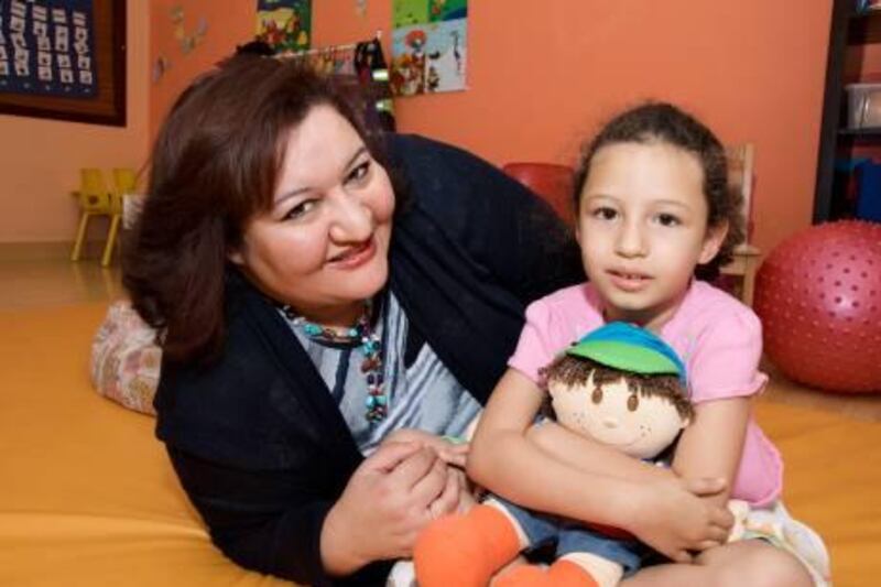 Dr Hibah Shata, managing director and co-founder of the Child Early Intervention and Medical Centre, with her six-year-old daughter Sara at the centre. Photo Courtesy Child Early Intervention and Medical Centre