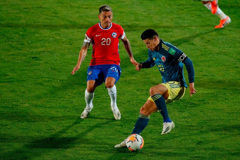 James Rodriguez is challenged by Charles Aranguiz. AFP