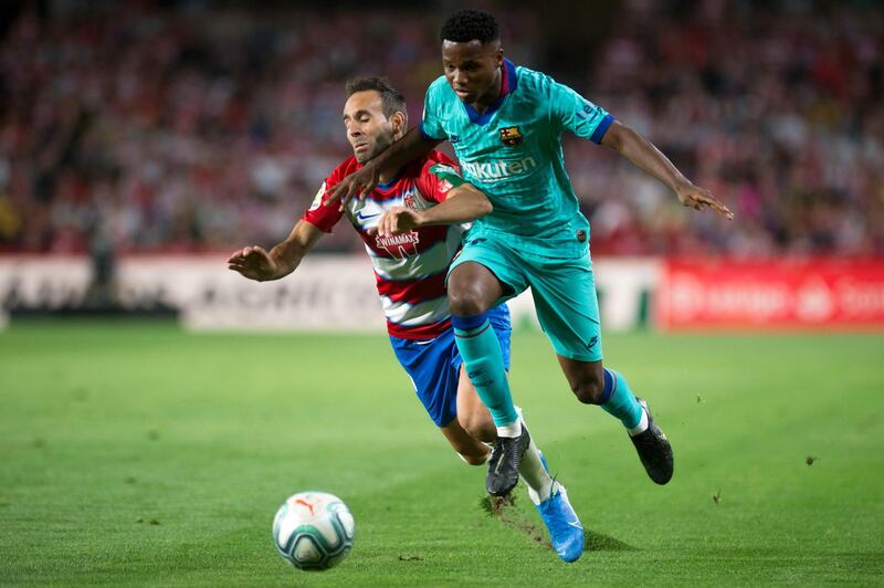 Granada's Spanish defender Victor Diaz vies with Barcelona's Guinea-Bissau forward Ansu Fati. AFP