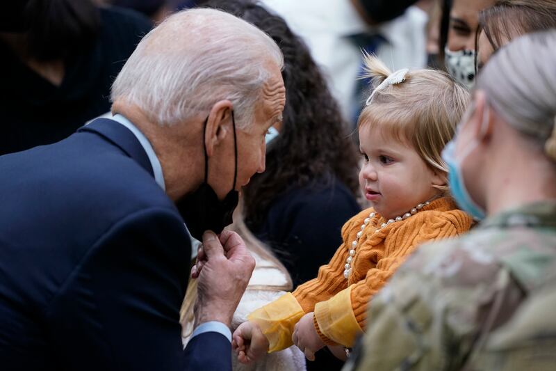 US President Joe Biden greets a young child during a visit to Fort Bragg to mark the upcoming Thanksgiving holiday on Monday. AP Photo