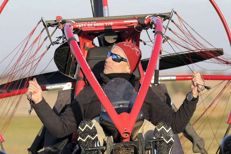 DUBAI, UNITED ARAB EMIRATES , January 13 – 2021 :- Pilot Alexandr Ctitor getting ready to fly after the sunrise at the Paramotor Desert Adventure Aviation Club on Dubai- Al Ain road in Dubai. (Pawan Singh / The National) For News/Online. Story by Sarwat