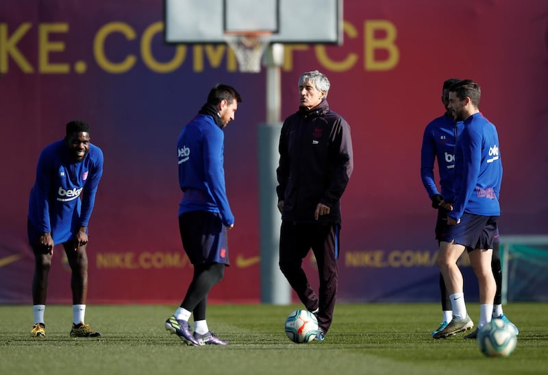 Barcelona manager Quique Setien and Lionel Messi during training. Reuters
