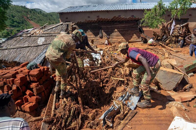 Soldiers help residents retrieve their lost belongings in Chimanimani. AFP