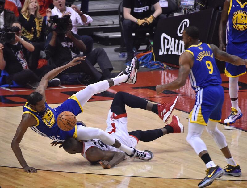 Golden State Warriors forward Kevin Durant, left, and Toronto Raptors centre Serge Ibaka collide during the first half of the NBA Finals Game 5 at Scotiabank Arena in Toronto, Canada. EPA
