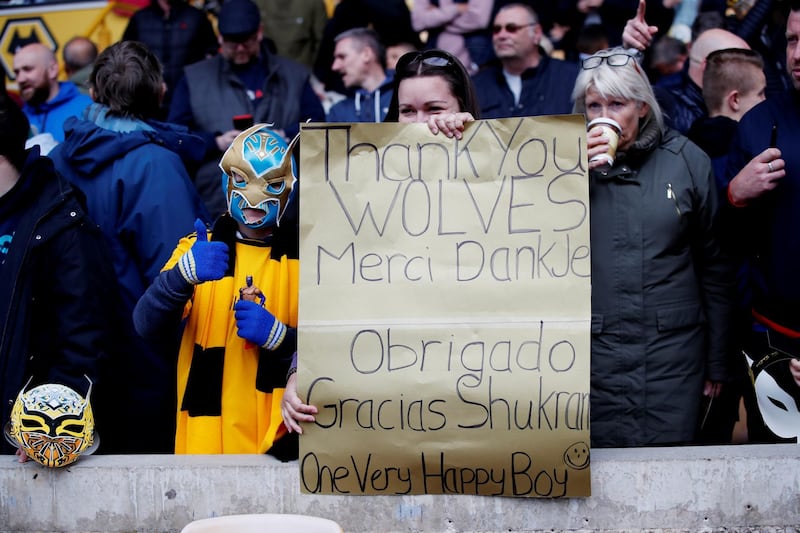 A Wolverhampton Wanderers fan holds up a sign before the 1-0 win over Fulham on May 4. Reuters.