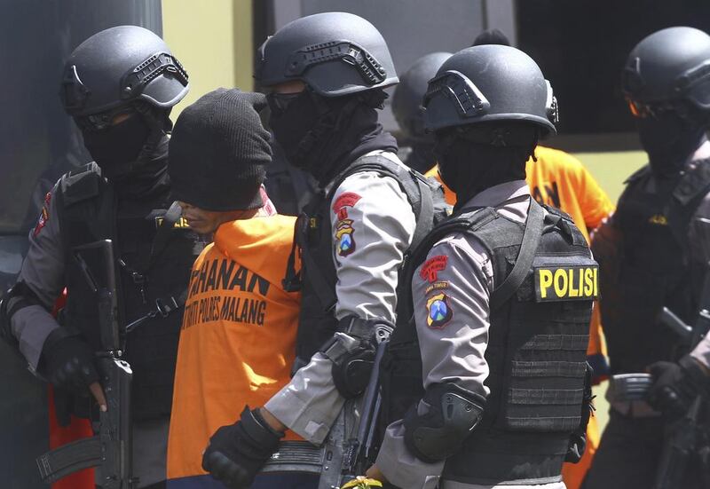 Indonesia’s elite anti-terror squad escorts suspects in a January 2016 bombing in Jakarta. ISIL claimed responsibility for the attack, and Indonesia is concerned about the return of an estimated 500 nationals who are believed to still be in Syria and Iraq, as the extremist group loses ground in the region. Associated Press