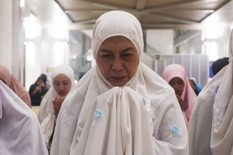 A Malaysian Muslim woman offers prayers for passengers in Putrajaya, Malaysia. Joshua Paul / AP Photo March 9
