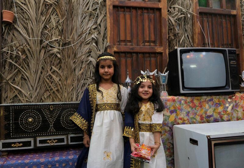 Girls dressed in traditional outfits pose for a photograph during Gargee'an in Qatif, Saudi Arabia. Reuters
