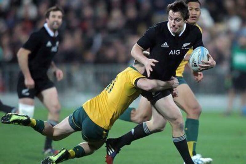 Ben Smith of New Zealand is tackled by James O'Connor of Australia.