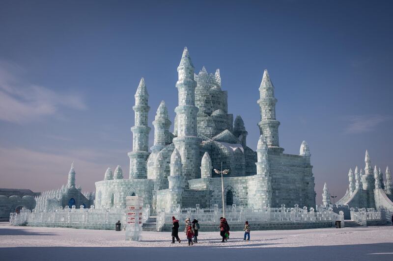 Visitors walk next to the ice sculptures at the annual Harbin International Ice and Snow Festival, in Harbin, Heilongjiang province, China. EPA