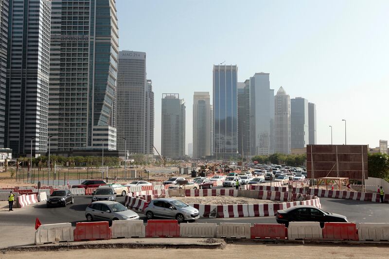 Dubai, United Arab Emirates - September 10, 2013.  Traffic building up as early as 8:30 am in this small temporary roundabout at the back of the JLT towers but slowly improving due to securities or traffic enforcers around the area, road construction in JLT is still ongoing.   ( Jeffrey E Biteng / The National )  Editor's Note;  Caline M reports. *** Local Caption ***  JB100913-Traffic06.jpg