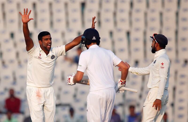 Ravichandran Ashwin, left, again India's dangerman, claiming three of four England wickets on Day 3 in Mohali. Adnan Abidi / Reuters