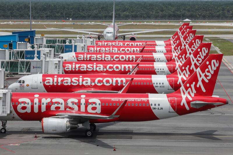 FILE PHOTO: AirAsia planes are seen parked at Kuala Lumpur International Airport 2, during the movement control order due to the outbreak of the coronavirus disease (COVID-19), in Sepang, Malaysia April 14, 2020. REUTERS/Lim Huey Teng/File Photo