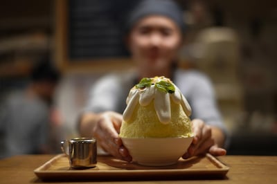 A waitress serves a "Durian Sticky rice kakigori" at an After You dessert cafe at a department store in Bangkok, Thailand, May 3, 2018. Picture taken May 3, 2018. REUTERS/Athit Perawongmetha