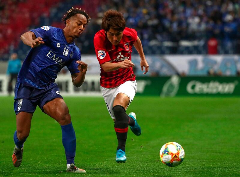 Urawa Reds’ forward Takahiro Sekine (R) fights for the ball with Al-Hilal's midfielder Andre Carrillo during the second leg of the AFC Champions League final football match between Japan's Urawa Red Diamonds and Saudi’s Al-Hilal in Saitama on November 24, 2019. / AFP / Behrouz MEHRI
