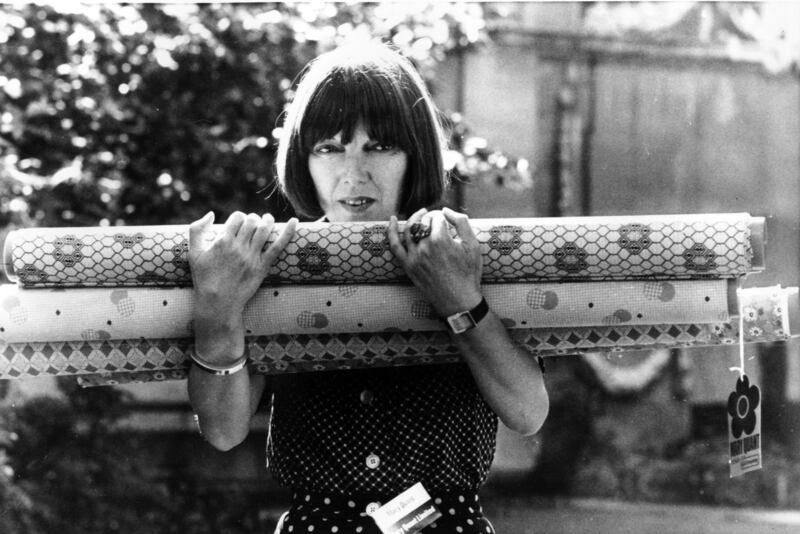 Quant with rolls of fabric in 1974. AP 
